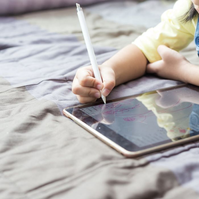 child writing on tablet